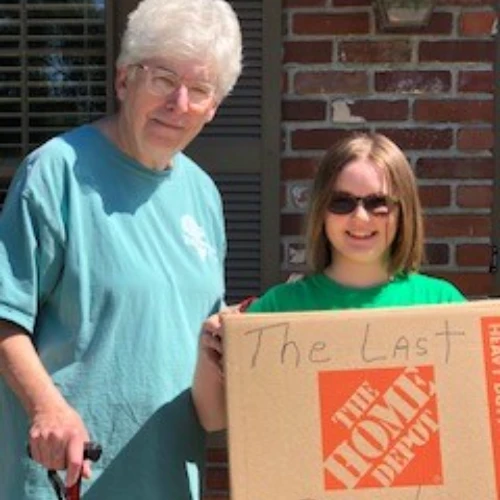 Family holding last moving box